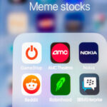 Icons of meme stocks on phone screen. meme stock crashes